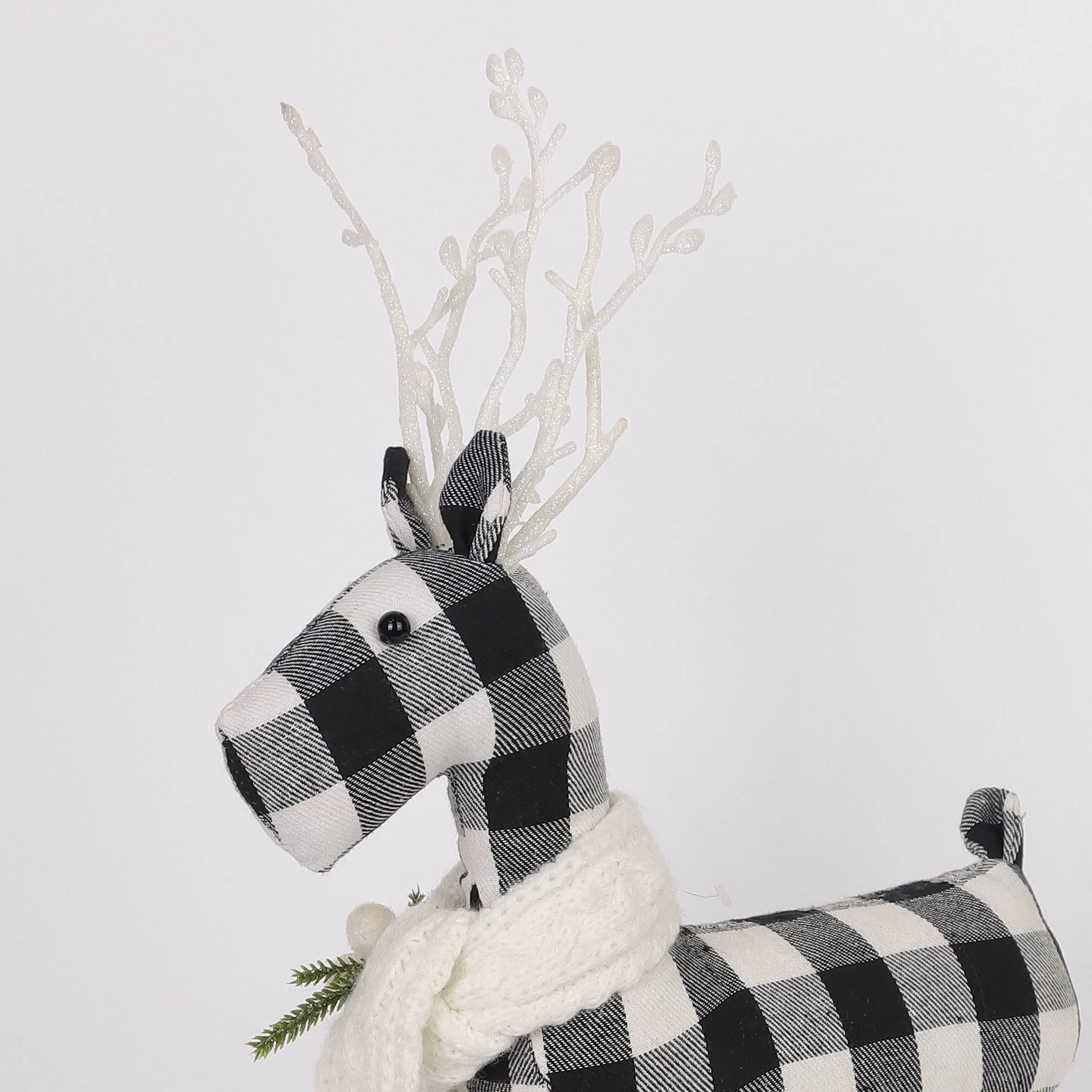 Black and white checkered 
reindeer with knitted scarf